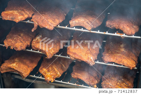 smoke rising around a slow cooked beef brisket on a smoker barbecue grilling concept smoke rising around a slow cooked beef brisket on a smoker barbecue grilling concept 71412837