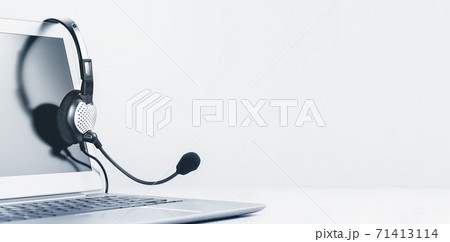 Laptop with headphones on white desk Laptop with headphones on white desk 71413114