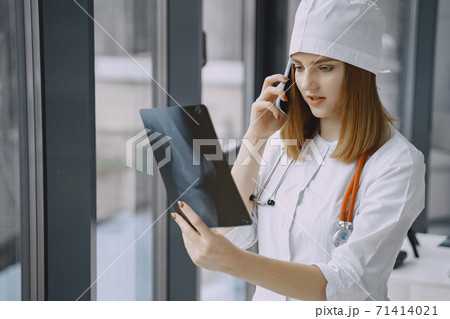 Woman doctor with white coat in hospital 71414021