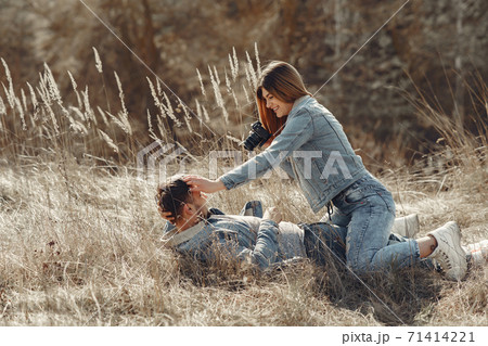 Cute couple in a jeans clothes in a spring field 71414221