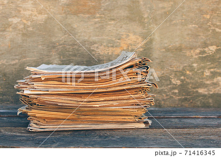 Newspapers and magazines on old wood background. Toned image. 71416345