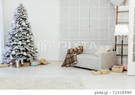 White snowy Christmas tree with gifts decor interior of the house new year postcard White snowy Christmas tree with gifts decor interior of the house new year postcard 71416490