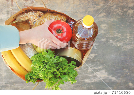Cardboard bag with products. Concept of people engaged in charity. Cardboard bag with products. Concept of people engaged in charity. 71416650