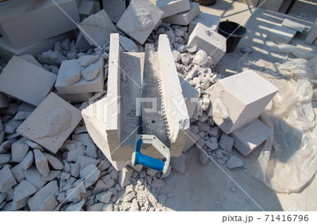 A worker cuts aerated concrete bricks with a saw. A worker cuts aerated concrete bricks with a saw. 71416796