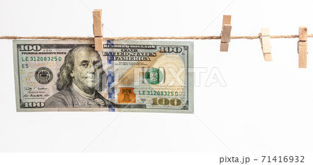 Dollars hang on a rope on a white Dollars hang on a rope on a white 71416932