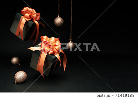 Falling gift boxes with orange ribbon, balls with copy space. Xmas present, Christmas banner 71419138
