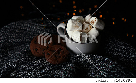 Mug with marshmallows and chocolate chip cookies on dark Christmas background 71420890