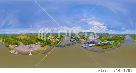 360 panorama by 180 degrees angle seamless panorama of aerial view of River Kwai Bridge with train rail way with Chao Phraya River, Tha Ma Kham, Mueang Kanchanaburi District, Thailand. 71421789