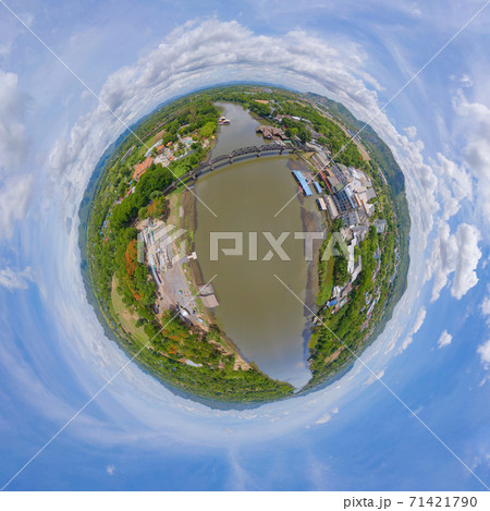 Little planet 360 degree sphere. Panorama of aerial view of River Kwai Bridge with train rail way with Chao Phraya River, Tha Ma Kham, Mueang Kanchanaburi District, Thailand. Little planet 360 degree sphere. Panorama of aerial view of River Kwai Bridge with train rail way with Chao Phraya River, Tha Ma Kham, Mueang Kanchanaburi District, Thailand. 71421790