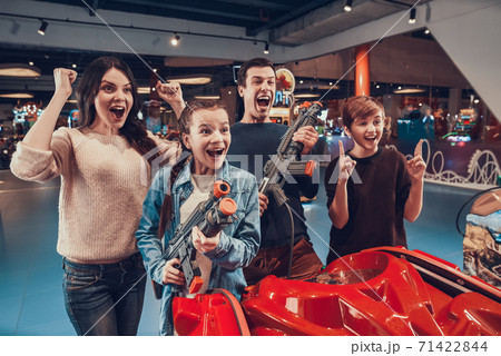 Family rejoices for playing well in a video game. Family rejoices for playing well in a video game. 71422844