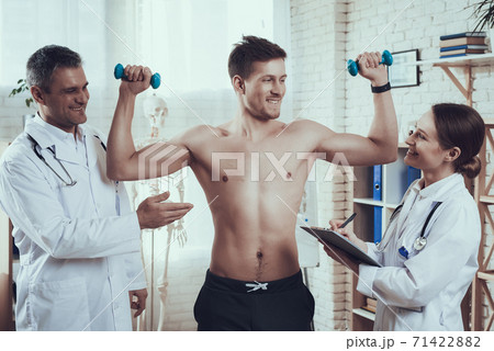 Athlete showing his physical form to doctors. 71422882