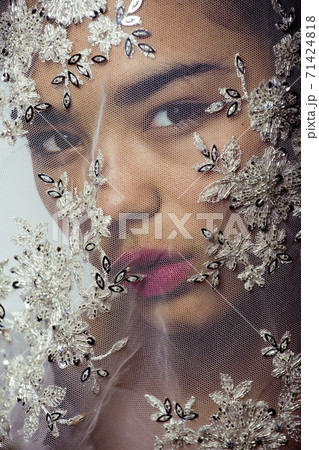 portrait of beauty young afro woman through white lace, like new bride under veil close up 71424818