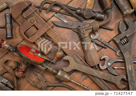 Vintage tools on a wooden background 71427547