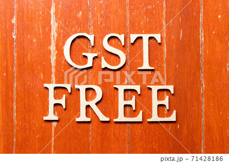 Alphabet letter in word GST (Abbreviation of Goods and Services Tax) free on old red color wood plate background 71428186