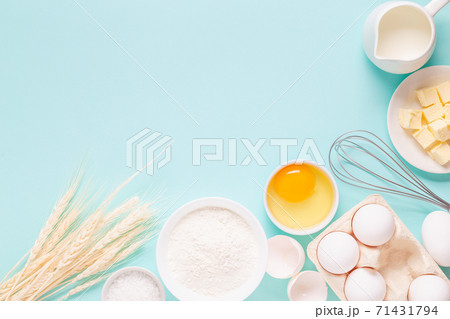 Ingredients for baking on light blue background. Ingredients for baking on light blue background. 71431794