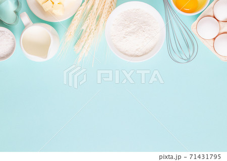 Ingredients for baking on light blue background. Ingredients for baking on light blue background. 71431795