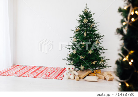 Christmas tree pine with gifts for the new year of the white room 2021 2022 Christmas tree pine with gifts for the new year of the white room 2021 2022 71433730