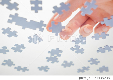 Bottom View. Male Hands Assembling Jigsaw Puzzle. Pastime, a hobby. Complex project management. Playing Calm Board Game. Unfinished Puzzle. Learning Concept. Finding Solution. Task and subtask concept 71435235