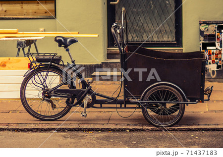 tricycle (bicycle) bike with a basket on the street of Copenhagen, Denmark 71437183