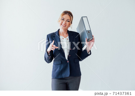 Beautiful woman in business suit with office folders for papers 71437361