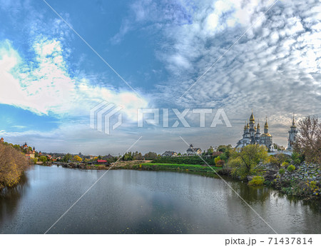 Panoramic view of the Rostavitsya river and the landscape park with the Orthodox Christian church of St. Eugene with cupoladomes and crosses in the village. Buky, Ukraine 71437814
