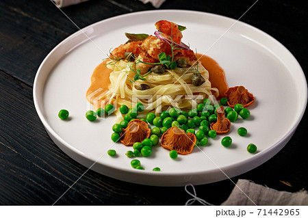 Chef Original Recipe: Pasta and fried shrimps with green peas and original chanterelle sauce. Healthy and tasty food. 71442965