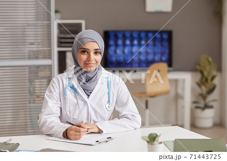 Female doctor sitting at office 71443725