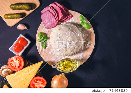 Ingredients for traditional Italian pizza Caprice Flat lay. ham, tomato sauce, garlic, spices, cheese, Basil, mushrooms Ingredients for traditional Italian pizza Caprice Flat lay. ham, tomato sauce, garlic, spices, cheese, Basil, mushrooms 71443886