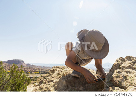 young boy taking pictures with his smart phone 71444376