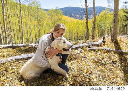teenage girl embracing her English Cream Golden Retriever 71444699