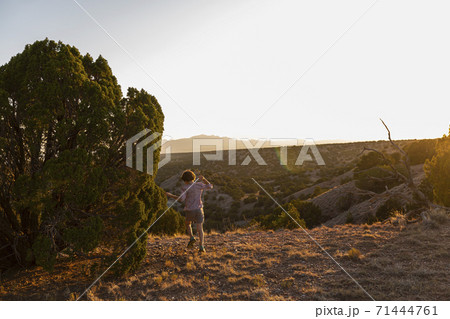 Young boy running in Galisteo Basin, Santa Fe 71444761