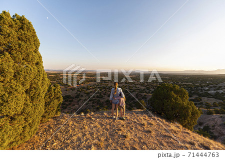 Teenage girl embracing her younger brother in the Galisteo Basin, Santa Fe 71444763