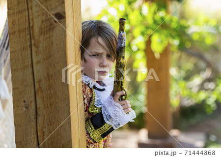 Young boy dressed as a pirate holding long pistol. Young boy dressed as a pirate holding long pistol. 71444868