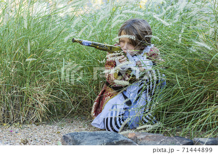 Young boy dressed as a pirate holding long pistol. Young boy dressed as a pirate holding long pistol. 71444899
