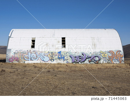 Building in a desert with a domed roof, damage, abandoned, with graffiti tags. Building in a desert with a domed roof, damage, abandoned, with graffiti tags. 71445063
