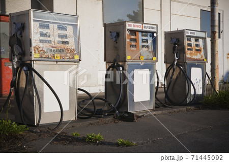 Row of gas pumps at a derelict gas station, 71445092