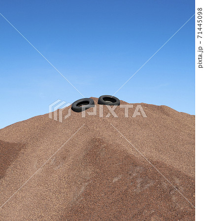 Heap of gravel with rubber tires, blue sky 71445098