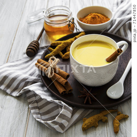 Yellow turmeric latte drink. Yellow turmeric latte drink. 71447850