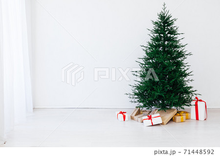 Christmas tree pine with gifts for the new year of the white room 2021 2022 Christmas tree pine with gifts for the new year of the white room 2021 2022 71448592