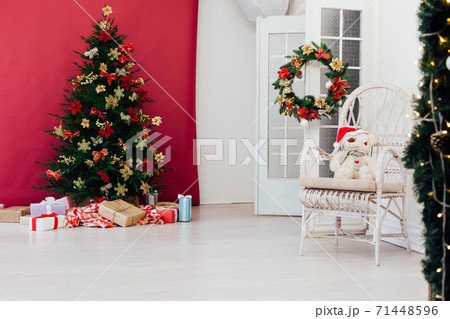 red decor garland Christmas tree with gifts for the new year interior red decor garland Christmas tree with gifts for the new year interior 71448596