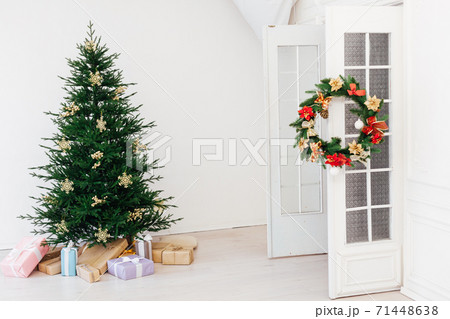 Christmas tree pine with gifts for the new year interior of the white room Christmas tree pine with gifts for the new year interior of the white room 71448638
