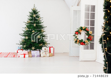 Christmas tree pine with gifts for the new year interior of the white room 71448639