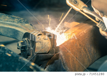 Welding Car Lower Arm by Welding Worker or Welder Man in Vintage Tone Welding Car Lower Arm by Welding Worker or Welder Man in Vintage Tone 71451280