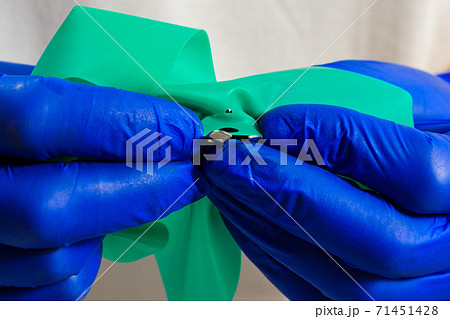 Dental procedure, installation of a cofferdam to the patient, modern treatment, preparation for installation. Dental procedure, installation of a cofferdam to the patient, modern treatment, preparation for installation. 71451428