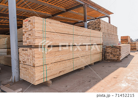 Piles of wooden boards in the sawmill, planking. Warehouse for sawing boards on a sawmill outdoors. Wood timber stack of wooden blanks construction material. Industry. Piles of wooden boards in the sawmill, planking. Warehouse for sawing boards on a sawmill outdoors. Wood timber stack of wooden blanks construction material. Industry. 71452215