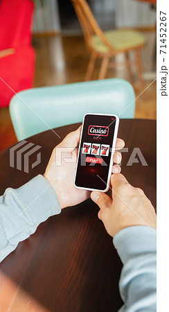 Online gambling, casino concept. Hand holding device with lottery, casino cover 71452267