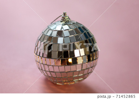 silver disco ball reflecting lights on pink background, greeting card wallpaper template with empty space for text silver disco ball reflecting lights on pink background, greeting card wallpaper template with empty space for text 71452865