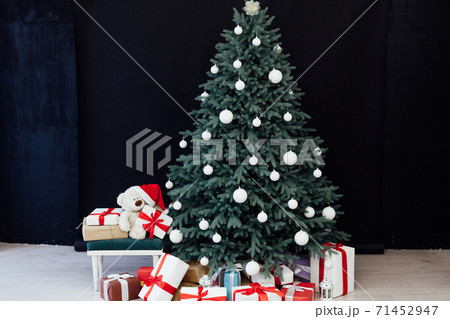 Christmas tree pine with gifts new year decor black background Christmas tree pine with gifts new year decor black background 71452947