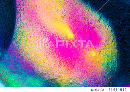 A fragment of colorful graffiti painted on a concrete wall. Abstract urban backdrop for design. A fragment of colorful graffiti painted on a concrete wall. Abstract urban backdrop for design. 71454612
