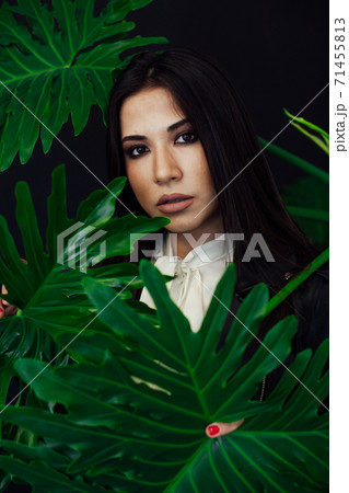 Beautiful fashionable brunette woman in a black leather jacket 71455813